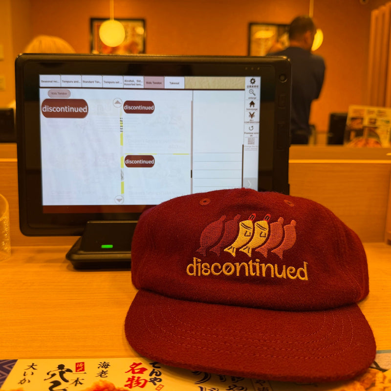 Red discontinued cap on a tempura restaurant counter